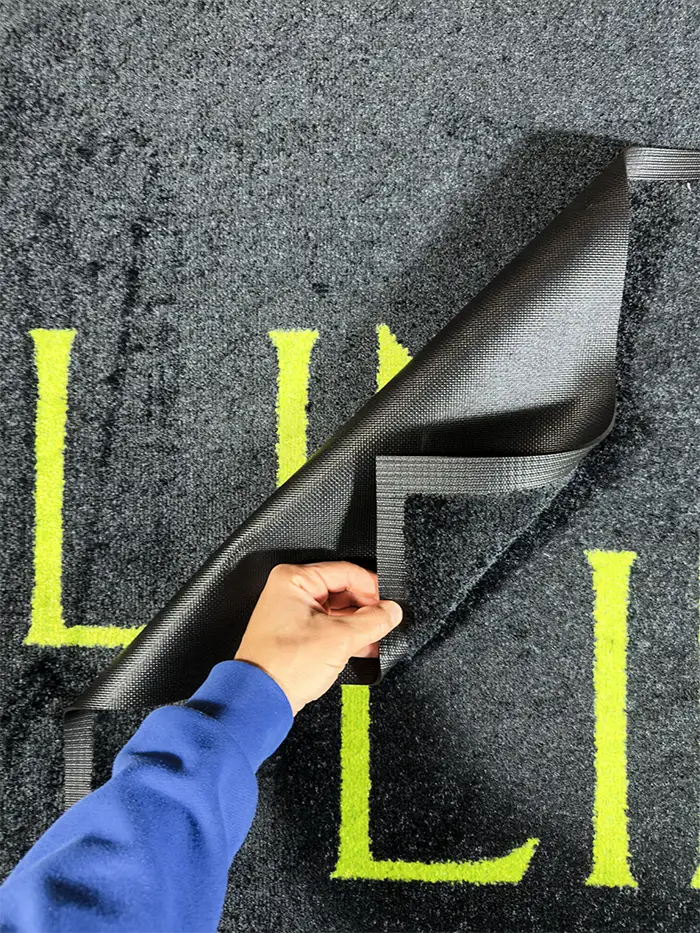 black backround green logo indoor logo mat closeup texture image